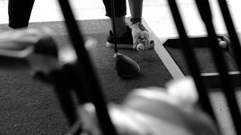 Golfer Practice Golf Swing with Her Driver in Driving Range and a Golf Bag Stockbeeldmateriaal 161220697