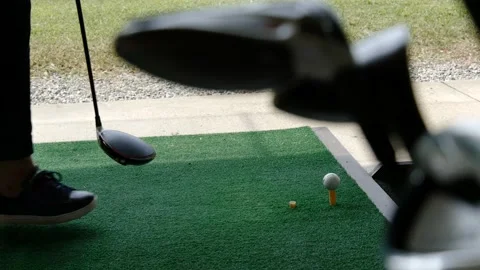 Golfer Practice Golf Swing with Her Driver in Driving Range and a Golf Bag Stock-Footage 161220698
