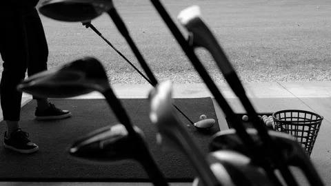 Golfer Practice Golf Swing with Her Driver in Driving Range and a Golf Bag 動画素材 162299307