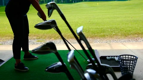 Golfer Practice Golf Swing with Her Driver in Driving Range and a Golf Bag Видео 191951956