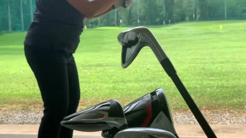 Golfer Practice Golf Swing with Her Iron Golf Club in Driving Range Stock-Footage 194011569
