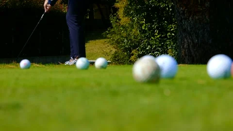 Golfer Practicing on Chipping Green and Putting the Golf Balls to the Hole Stock Footage 191952455