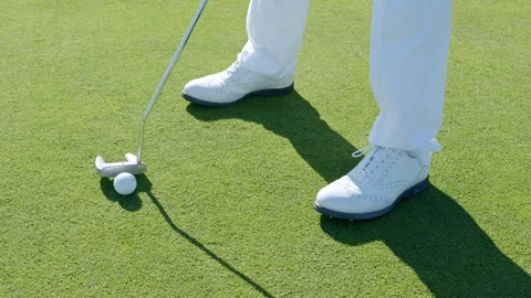 Golfer practicing putting at Grass Golf Club in afternoon sunlight Stock Footage 321471123