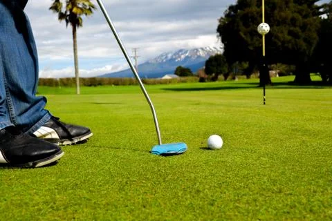 Golfer practicing putting on the green Stock Photos