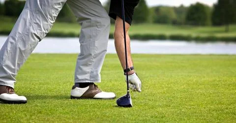 Golfer preparing for teeing off. Stock Photos