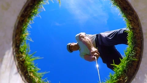 Golfer Putting and Picking Up the Golf Ball from the Golf Hole on the Golf Green 動画素材 112120632