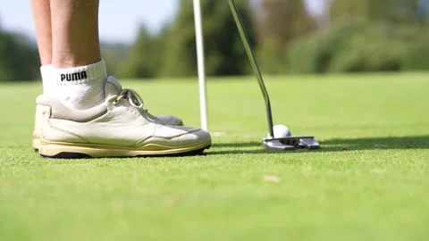 Golfer putting ball into hole on golf course green 스톡 동영상 346449489