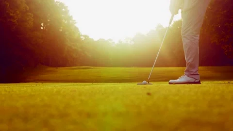 Golfer Putting Golf Ball on Green Course with Lens Flare Sunset Video stock 341824933