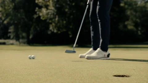 Golfer is putting the golf ball inside the hole Stock Footage 220293090