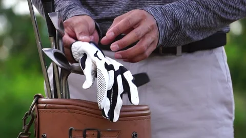 Golfer Putting on golf gloves to compete in golf Stock Footage 161893530