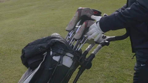 Golfer putting Putter back into bag Stock Footage 104563273