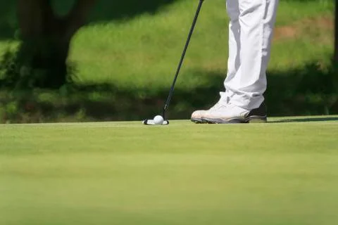 Golfer putting, selective focus on golf ball Stock Photos