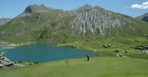 A Golfer putts golf ball on Alpine Course. Video stock 78225729