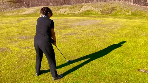Golfer with Shadow Training with Her Golf Club Hybrid on Driving Range Stockbeeldmateriaal 191936202