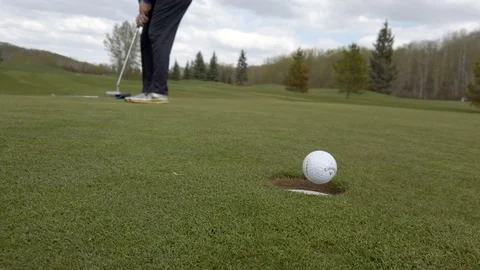 Golfer sinks long putt on putting green Stock Footage 108506663
