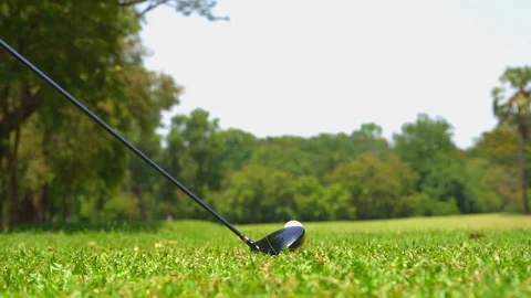 Golfer slow motion hitting golf ball in tee off zone to hole in one Stock Footage 106857765