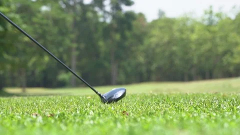 Golfer slow motion hitting golf ball in tee off zone to hole in one Vídeos de archivo 106861930