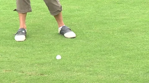 Golfer striking a ball Stock Footage 22303588