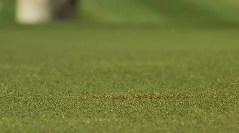 Golfer stroking and removing golf ball from hole, Canada Stock Footage 60690937