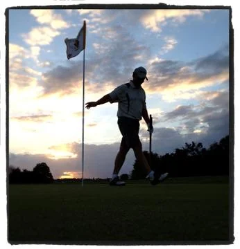 Golfer at Sunset Photos