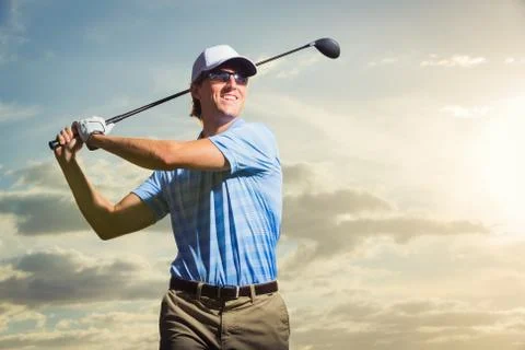 Golfer at sunset Stock Photos