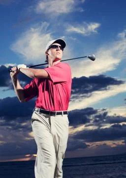 Golfer at sunset Stock Photos