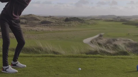 Golfer taking practise swings before hitting drive Stock Footage 104563595