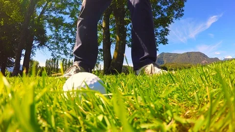 Golfer Taking a Shot with His Golf Wedge on the Grass in Slow Motion Stockbeeldmateriaal 112120633