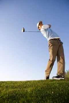 Golfer teeing off on the course Stock Photos