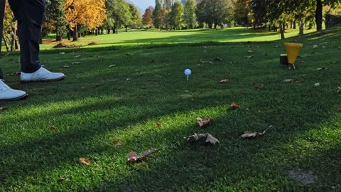 Golfer Teeing Off with His Driver on Golf Course with Mountain Stockbeeldmateriaal 220477309
