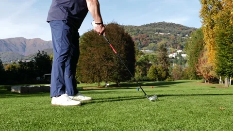 Golfer Teeing Off with His Iron Driver on a Par 3 Hole with Mountain 動画素材 220477298