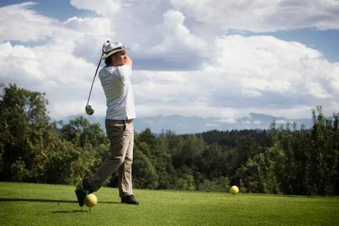 Golfer teeing off. Stock Photos