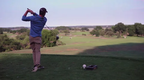 Golfer tees off on beautiful course Stock-Footage 60989919