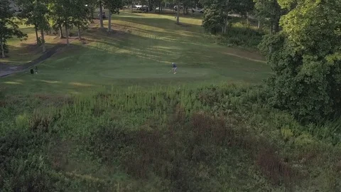 Golfer tees off in this thrilling fly by Stock Footage 79967198