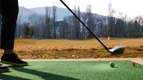 Golfer Training Golf Swing with 3 Wood in Driving Range on Mat in a Sunny Day 動画素材 191936361