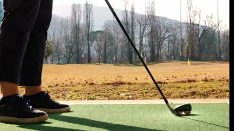 Golfer Training Golf Swing in Driving Range on Mat in a Sunny Day Stock Footage 194012136