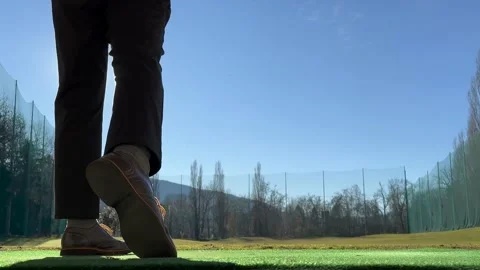 Golfer Training Golf Swing on Driving Range with Sunlight (Audio) Video stock 235427322