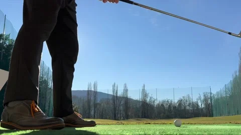 Golfer Training Golf Swing on Driving Range with Sunlight Stock Footage 236085860