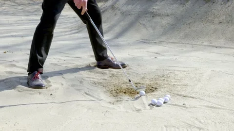 Golfer Training Golf Swing to Hitting Golf Ball in Sand Trap in a Sunny Day Vídeos de archivo 194012468