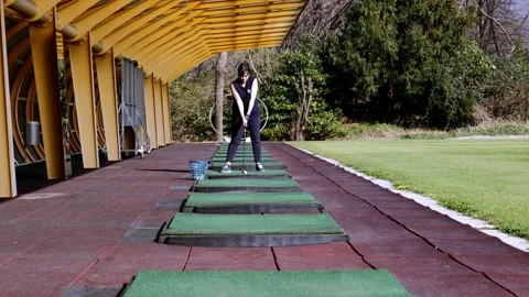 Golfer Training Golf Swing in a Modern Driving Range Stock Footage 194012542