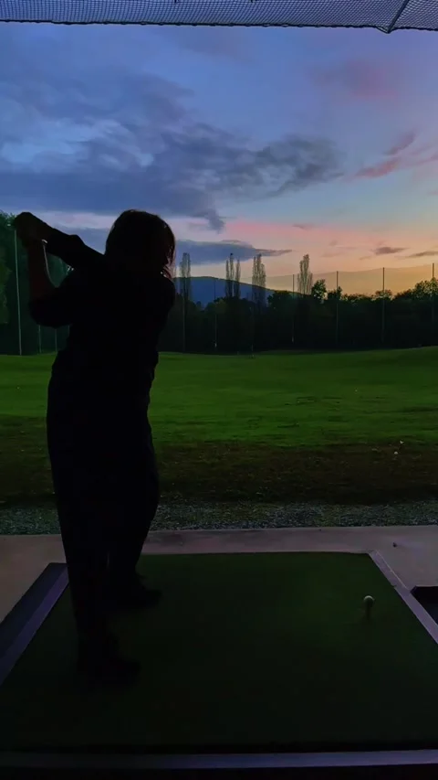 Golfer Training Her Golf Swing with Her Golf Club Driver in Driving Range Video stock 292157214