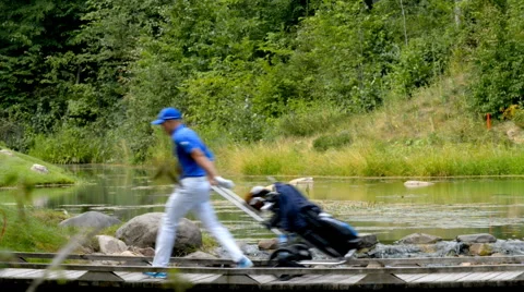 Golfer traverses the river Stock Footage 40649824