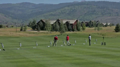 Golfers practice at a golf course driving range in Idaho Stock Footage 36303823