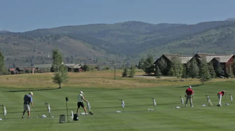 Golfers practice at a golf course driving range in Idaho Stock Footage 36303843