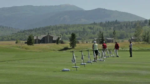 Golfers practice at a golf course driving range in Idaho Stock Footage 36304131