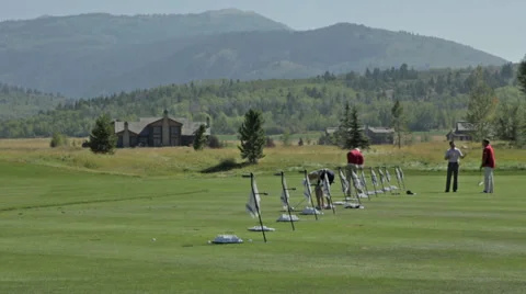 Golfers practice at a golf course driving range in Idaho Stock Footage 36304187