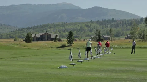 Golfers practice at a golf course driving range in Idaho Stock Footage 36304224