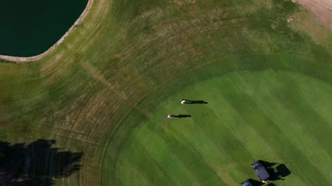 Golfers walking on green grass golf course Stock Footage 315364649