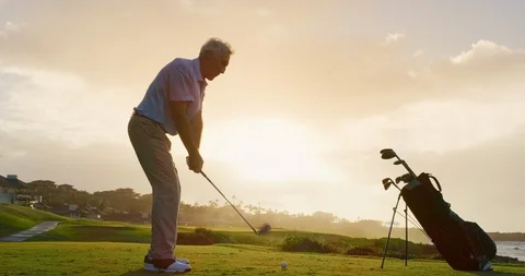 Golfing into the sunset Stock Footage 102409493