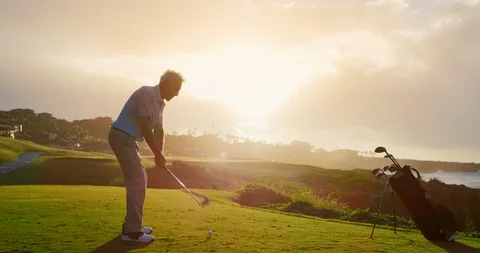 Golfing into the sunset Stock Footage 102409609